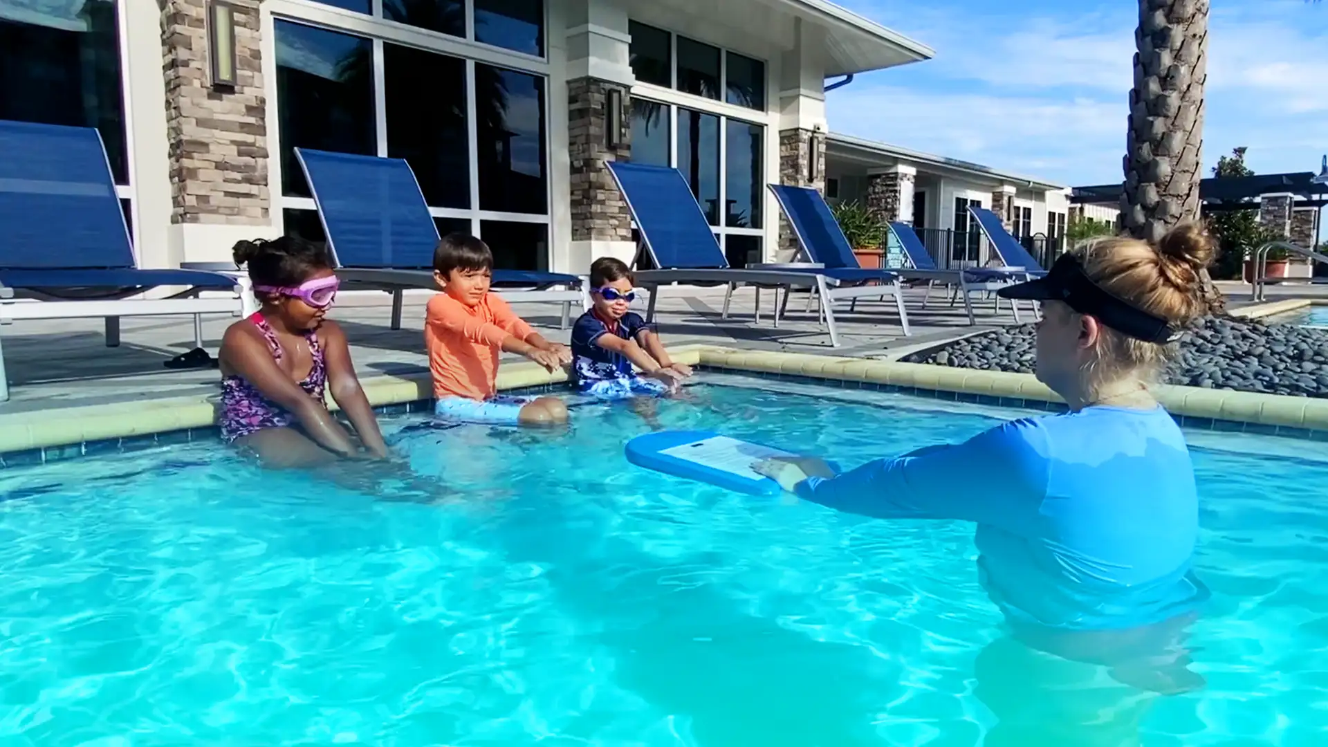 Learning with Confidence: Our dedicated instructor guides young swimmers through the basics of swimming with interactive, hands-on demonstrations.