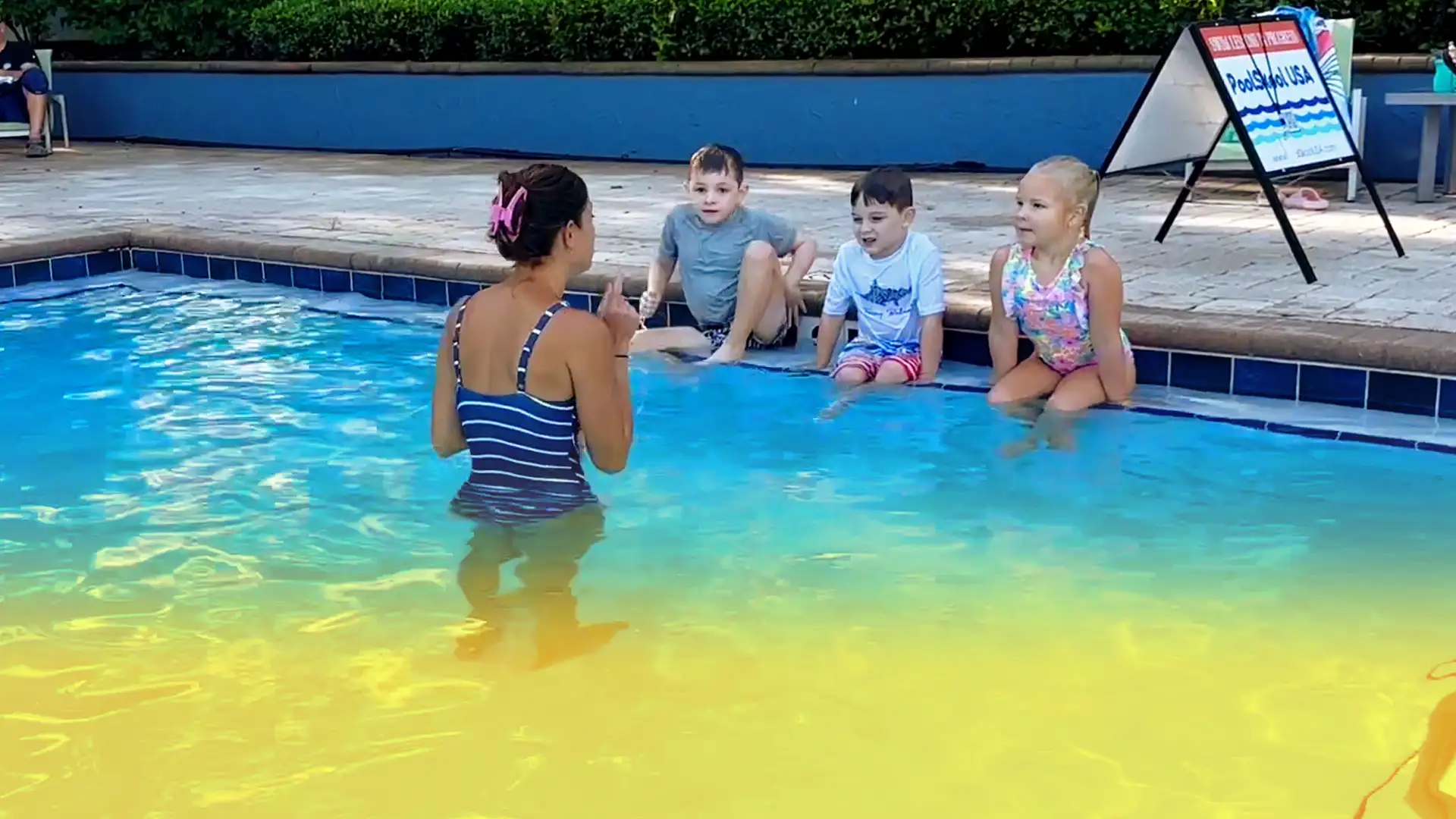 Learning water safety and swimming skills at PoolSkool USA with expert guidance and engaged young swimmers!